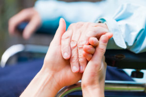 Young carer giving helping hands for the elderly woman