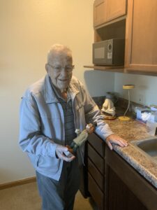 EverHeart Hospice Patient holds wood carving